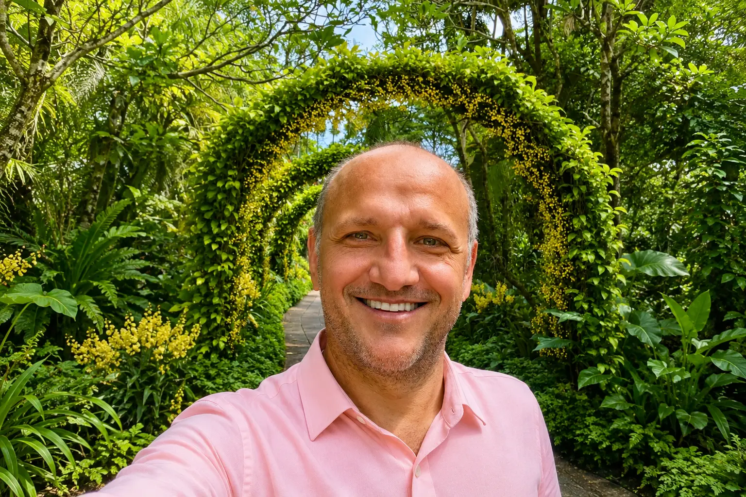 Portrait of Peter Erz in front of a green leafy walkway